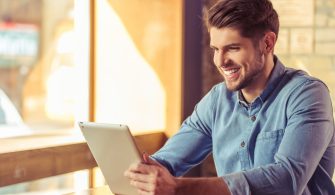 Handsome young businessman is using a tablet.