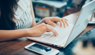 woman's hands busy working on her laptop