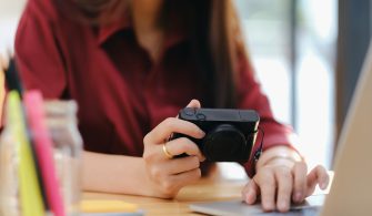 Photo artist and graphic desginer selecting pictures from camera