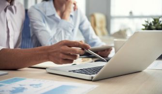 unrecognizable-male-female-colleagues-looking-laptop-screen-office_1098-17852