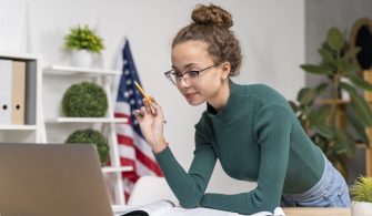 medium-shot-girl-studying-with-laptop