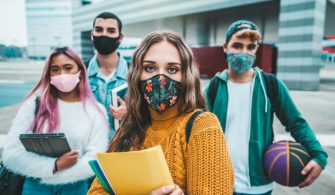 portrait-group-students-covered-by-face-masks-new-normal-lifestyle-concept-with-young-people-going-school-corona-virus-pandemic_169160-418