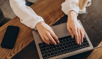 Female hands typing on computer close up