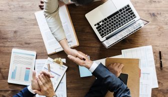 Business people shaking hands together