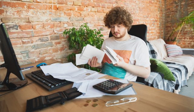 Caucasian upset and despair man doing financial and economical reports