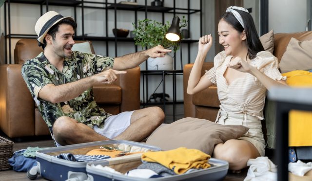 happy-couple-asian-caucasian-marry-lover-wear-casual-cloth-enjoy-packing-cloth-travel-stuff-luggage-floor-living-room-lover-couple-singing-funny-dance-together-home