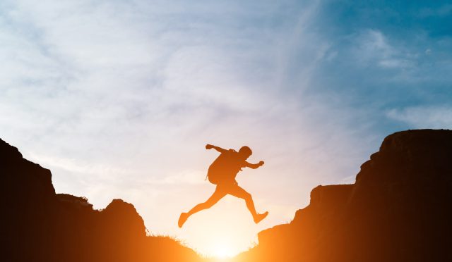 Man jump through gaps between hills