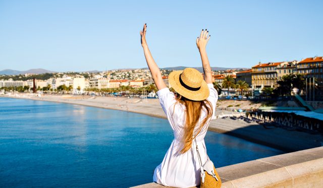 happy-elegant-woman-posing-back-put-her-hand-air-enjoying-amazing-view